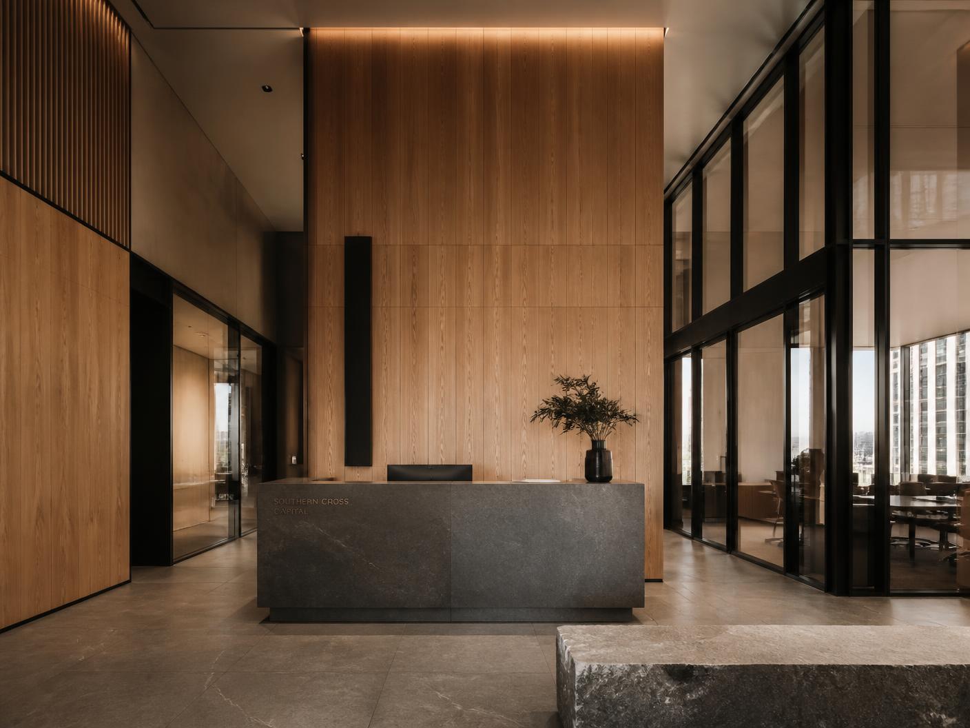 Premium corporate headquarters reception with full-height oak panelling and blackened steel glazing